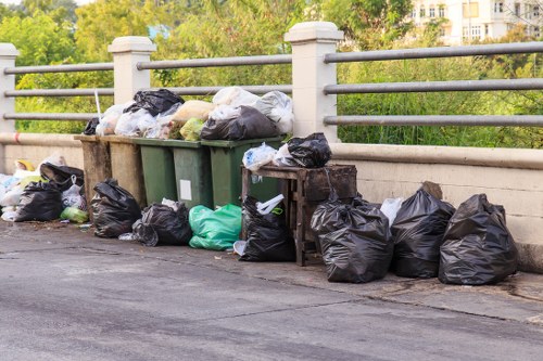Workers sorting office waste into recycling streams